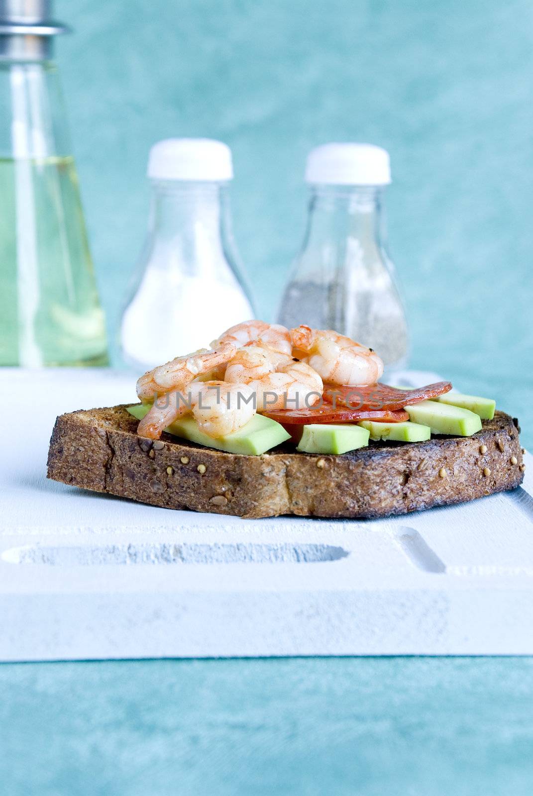 Brown toast with avocado, prawns and salami