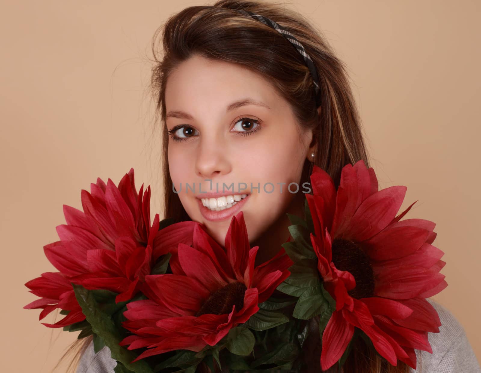 portrait of a beautiful young caucasian woman with fake flowers