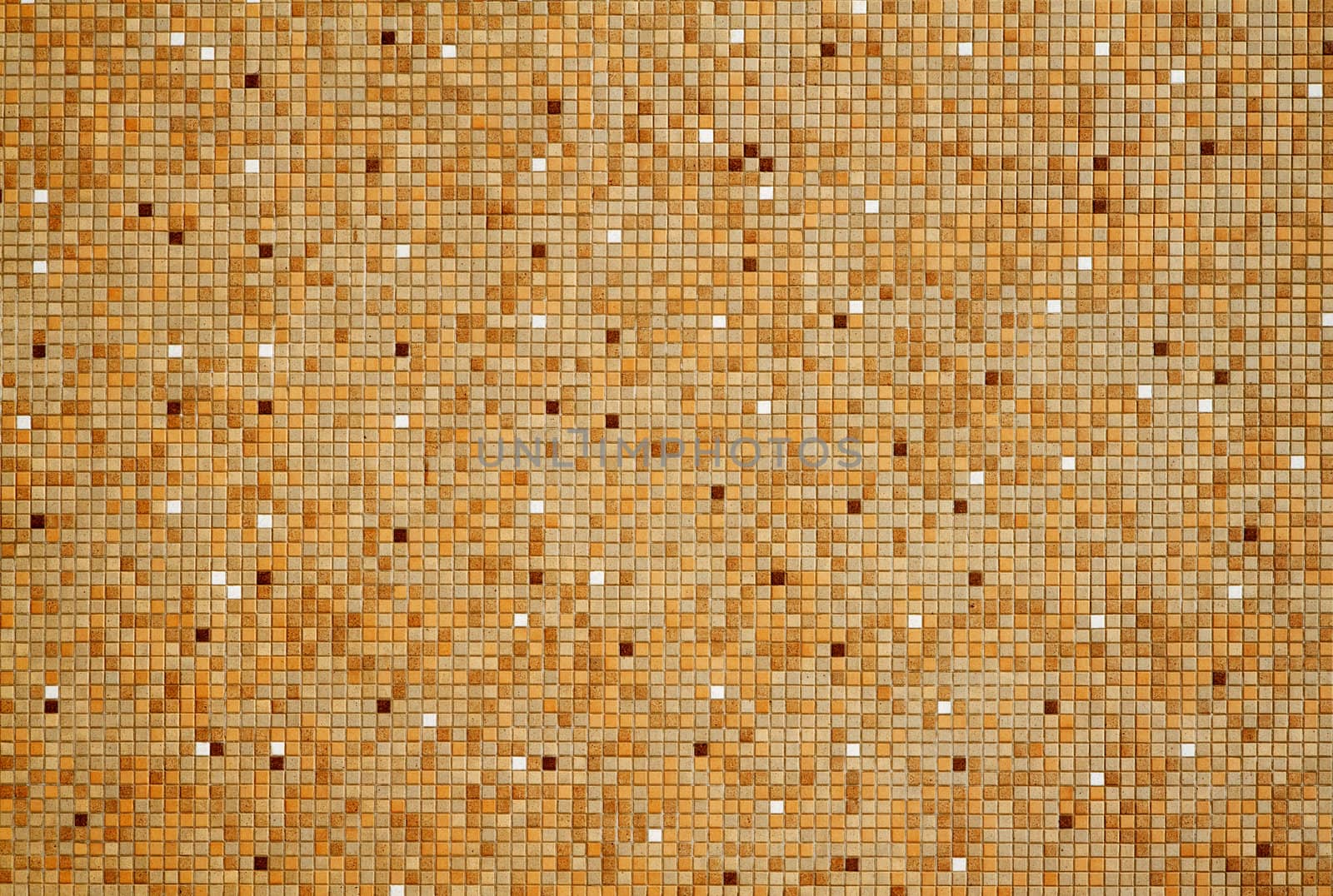 Sun lit wall with tan brown white mosaic tiles