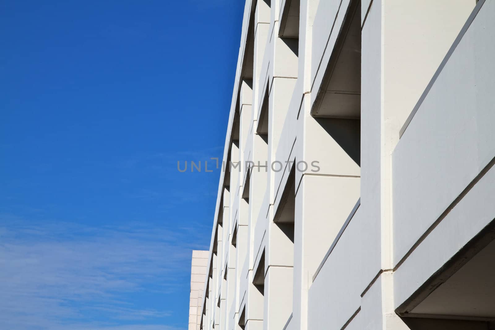 Tan Building  in perspective with blue sky and clouds background