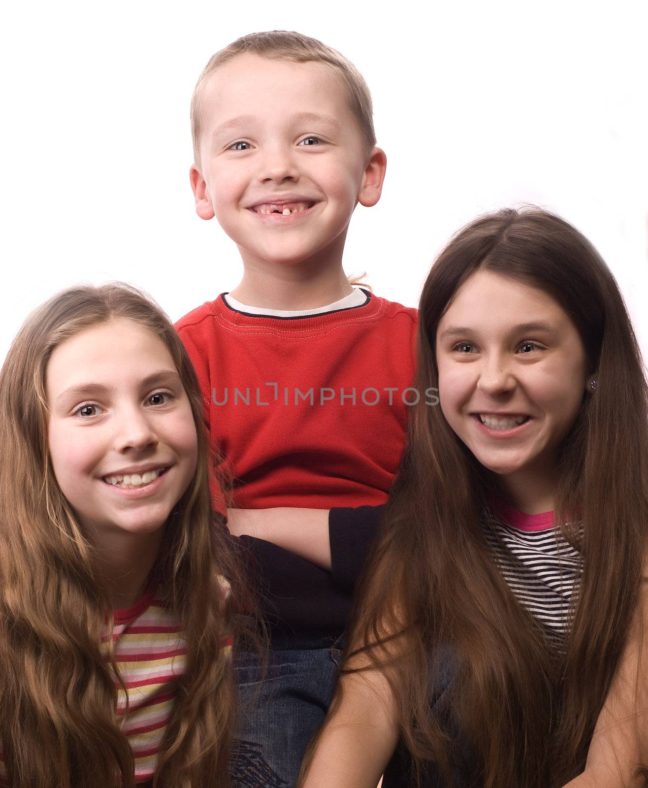 Two teenage girls and little boy smiling isolated on white by iribo