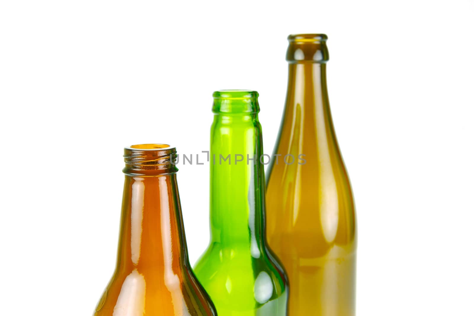 Empty beer bottles isolated against a white background