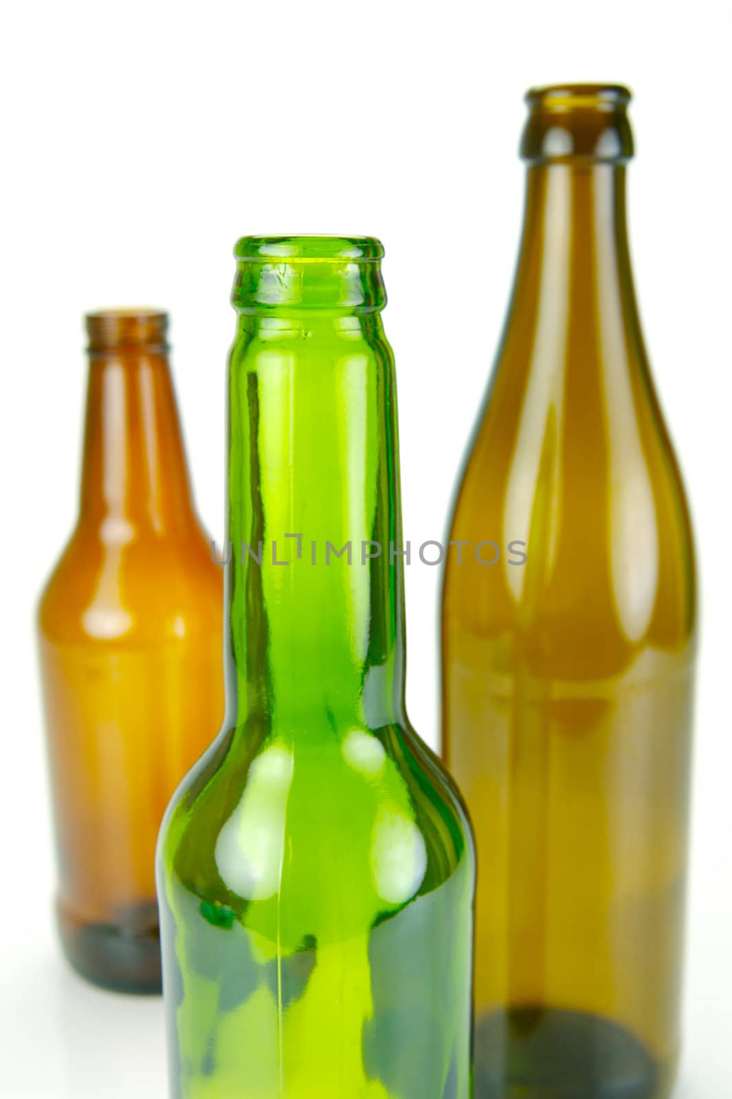 Empty beer bottles isolated against a white background