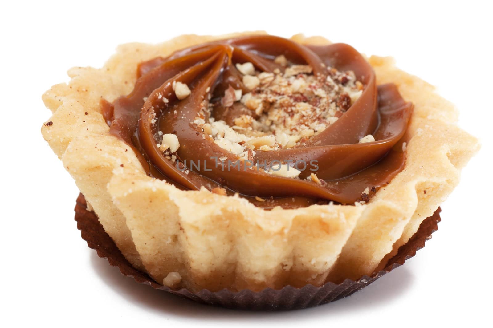A pastry with nuts isolated over white.