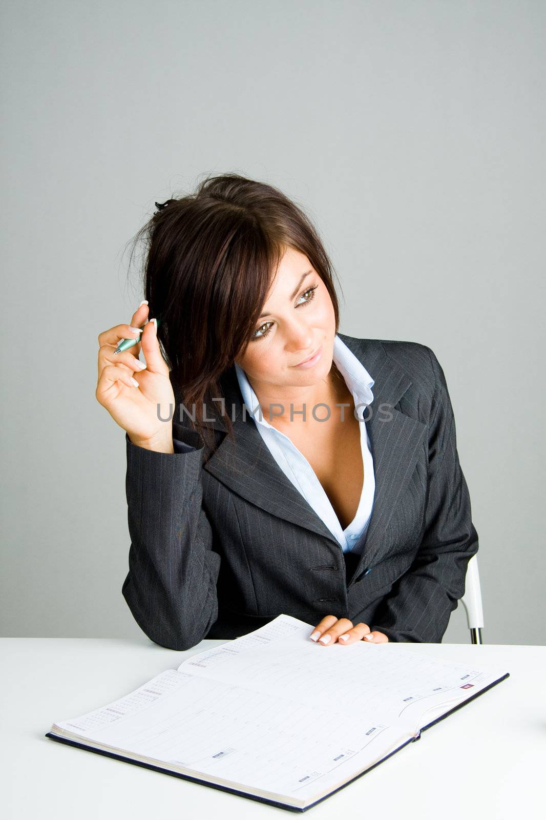 Young business woman writing in a diary