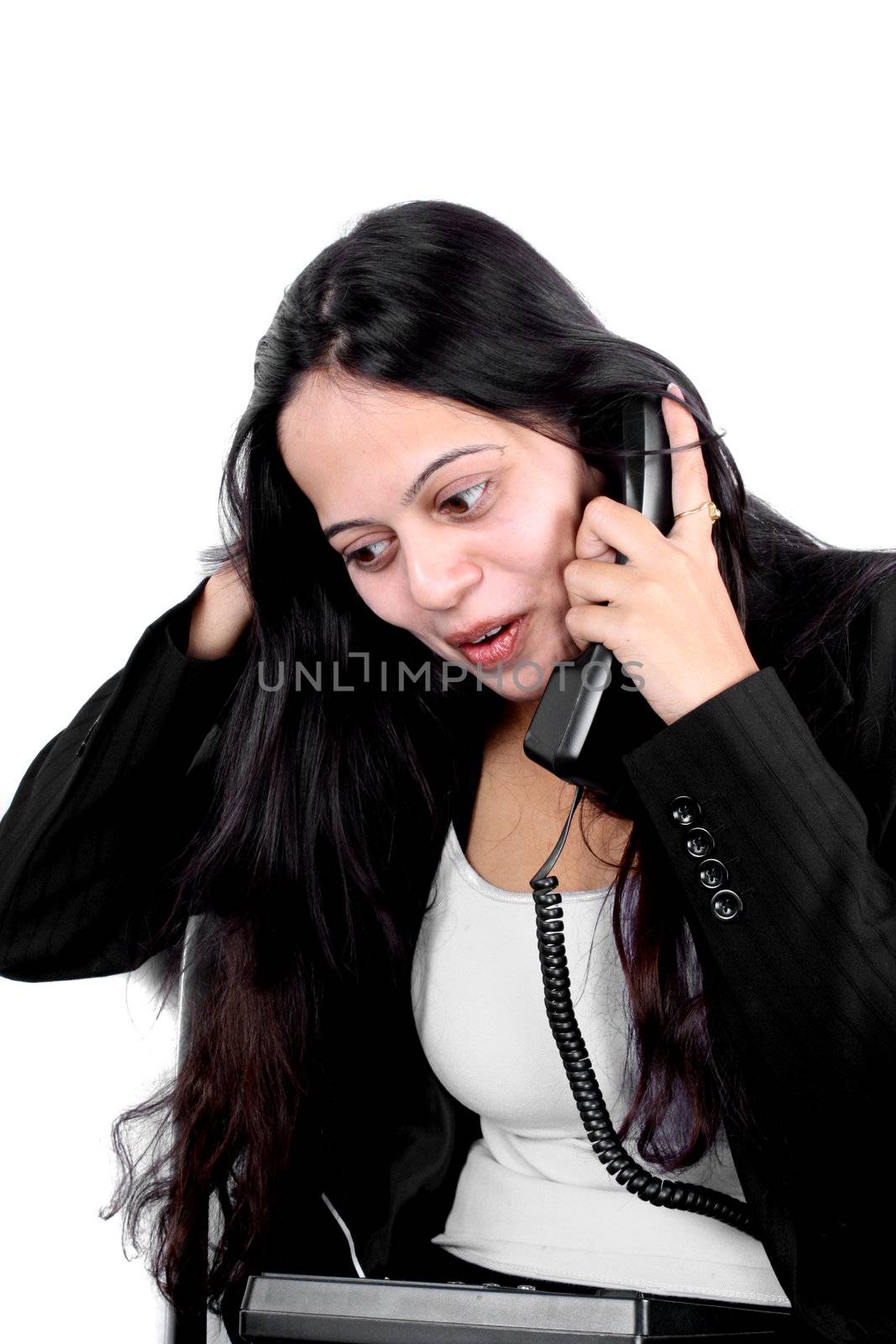 A beautiful Indian businesswoman talking on the phone.