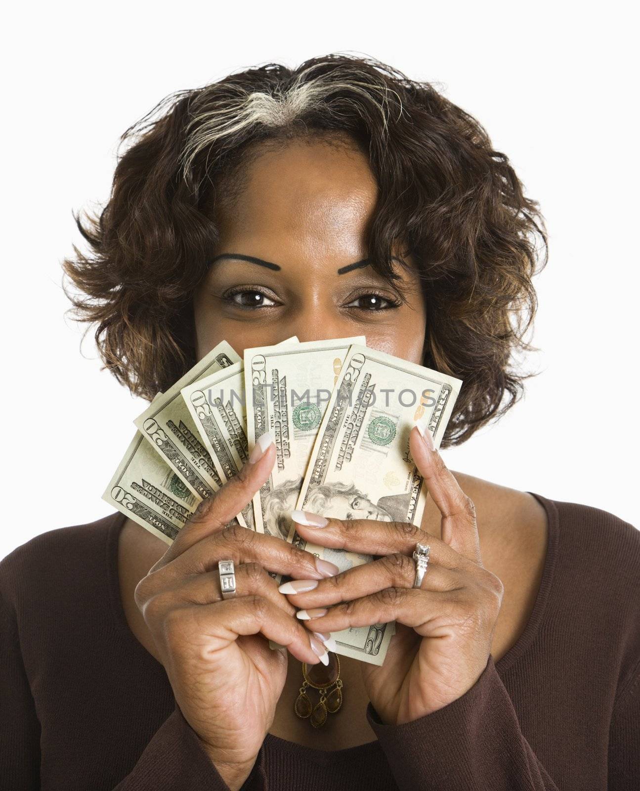 Portrait of woman holding twenty dollar bills in hand.