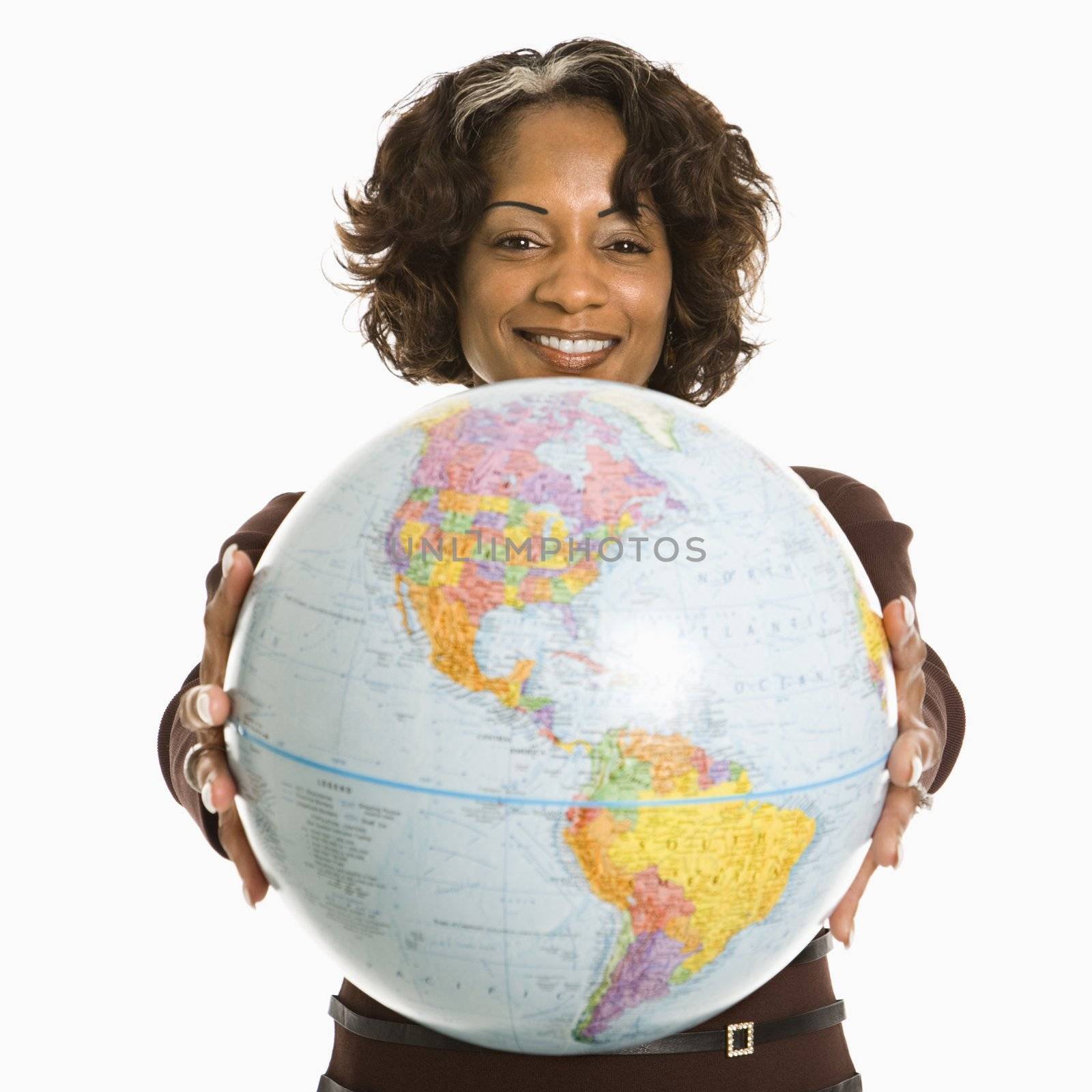 Smiling woman holding out world globe.
