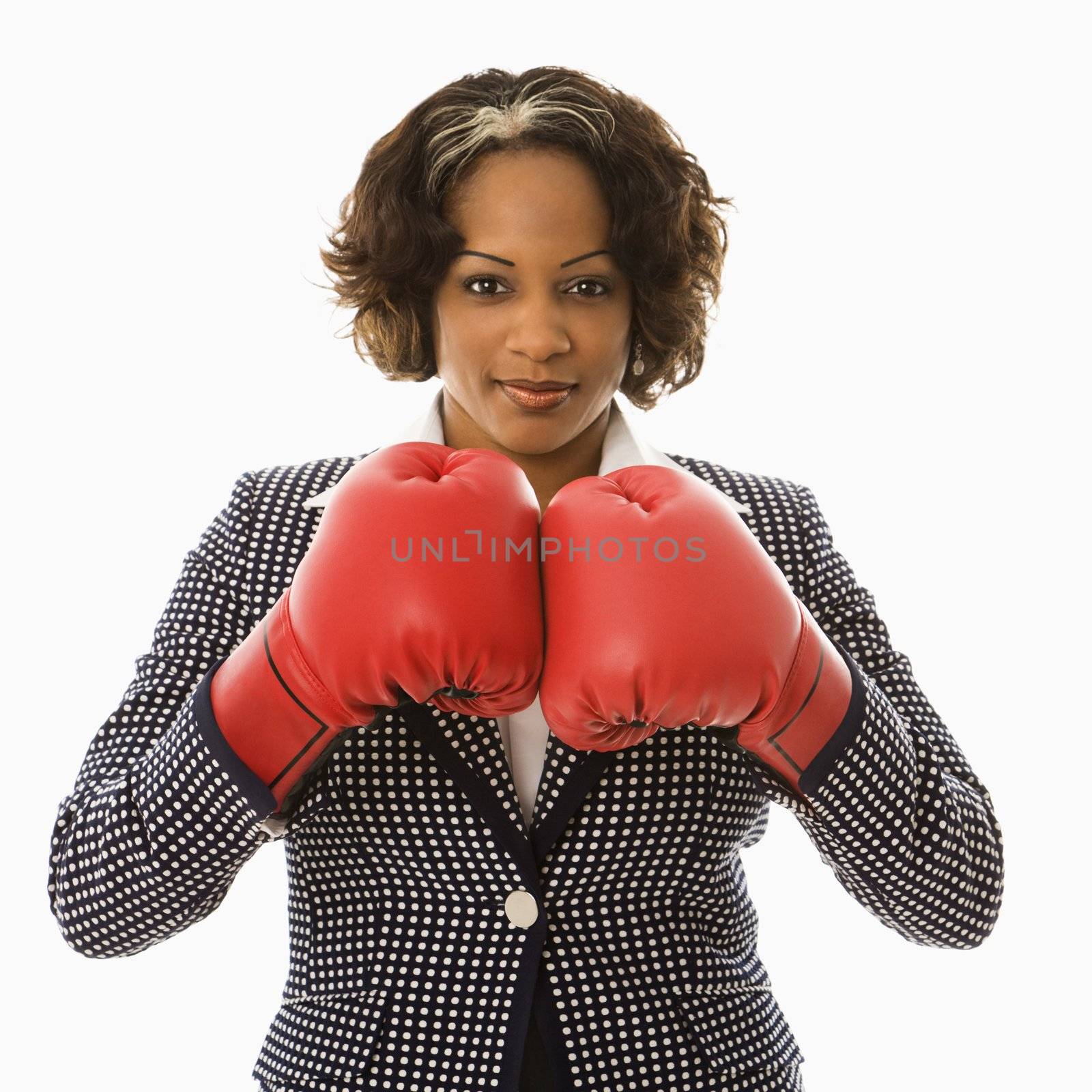 Businesswoman wearing boxing gloves.