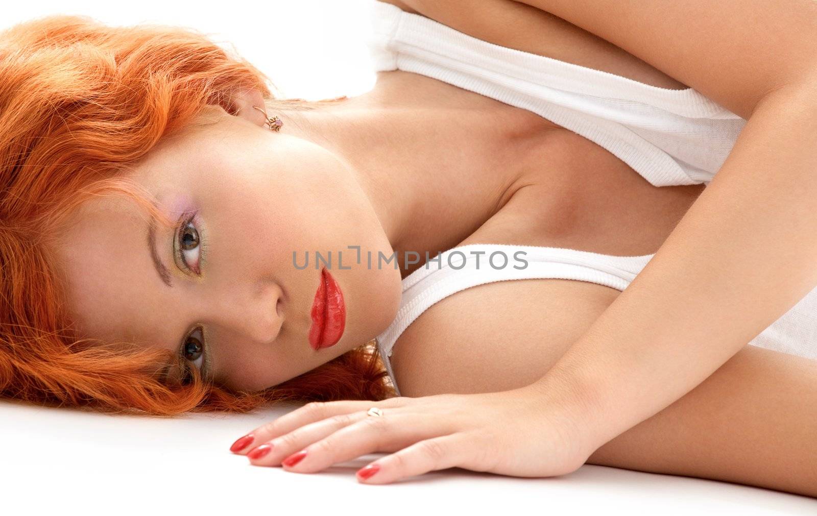 portrait of laying redhead in white shirt