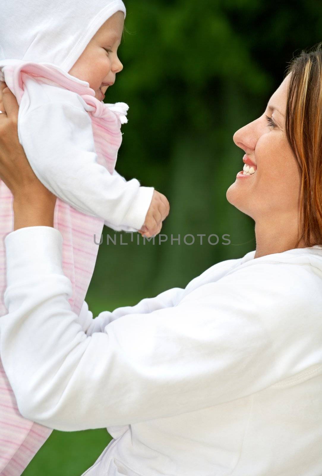 outdoor picture of happy mother with baby (focus on mom)