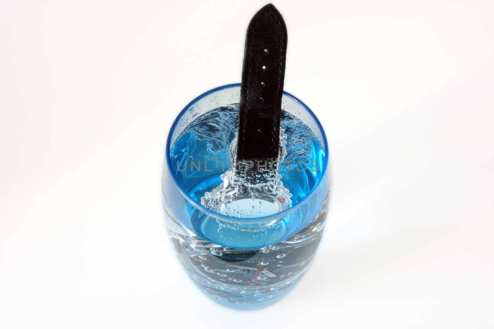 Waterproof watch in glass full of water. Service test.