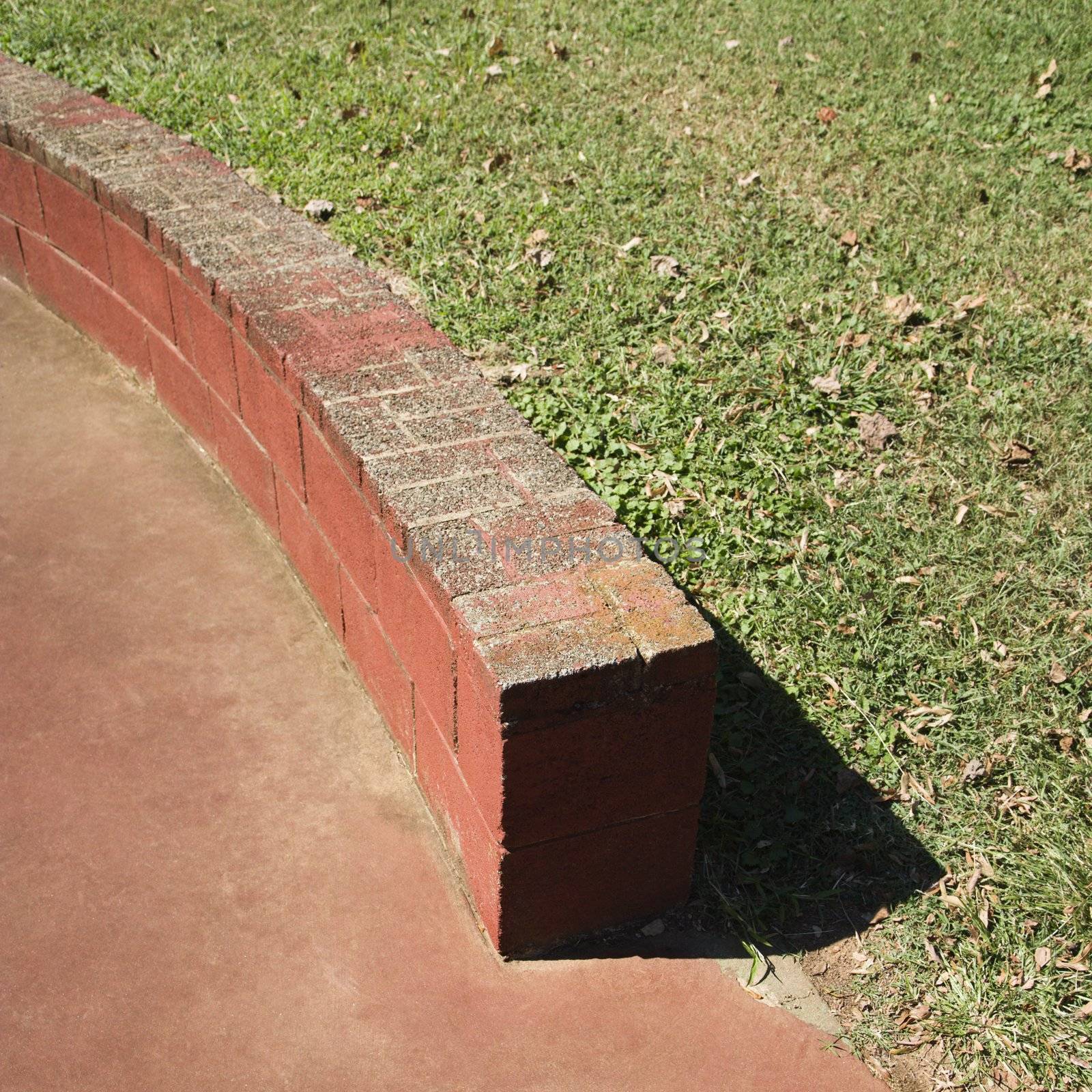 Low brick wall in park.