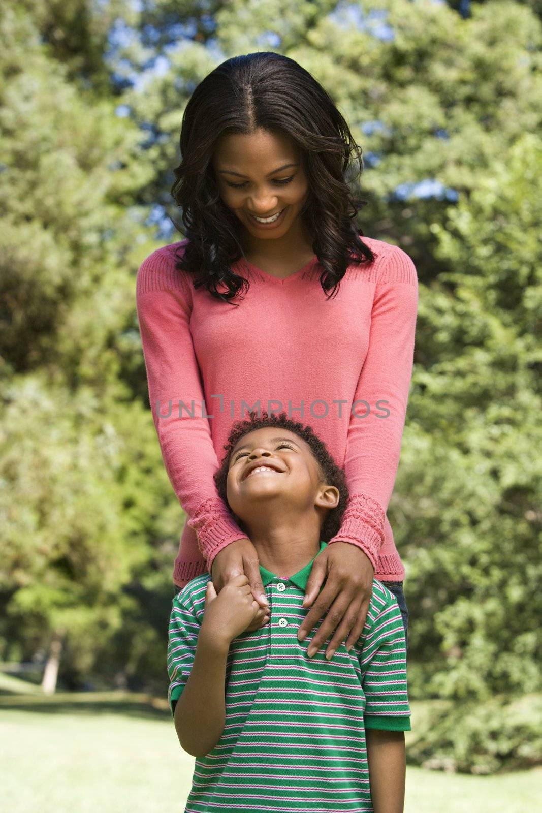 Mother and son looking at eachother smiling.