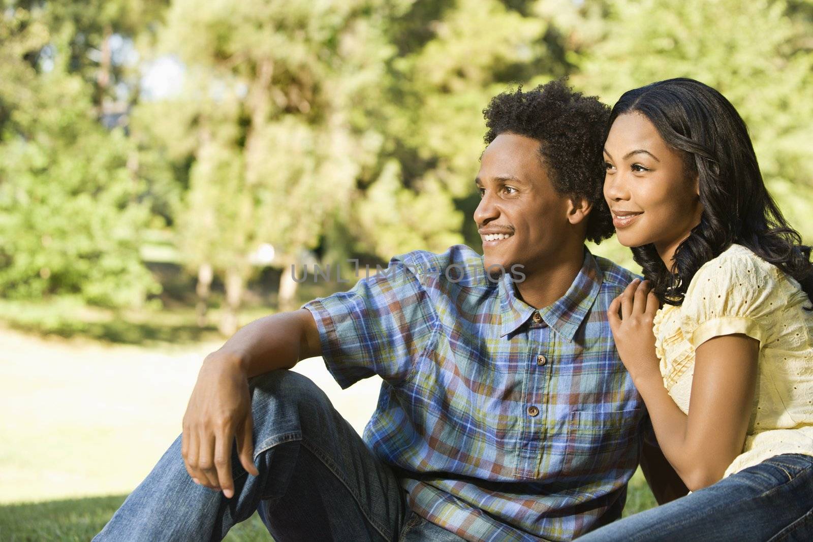 Portrait of attractive smiling couple in park.