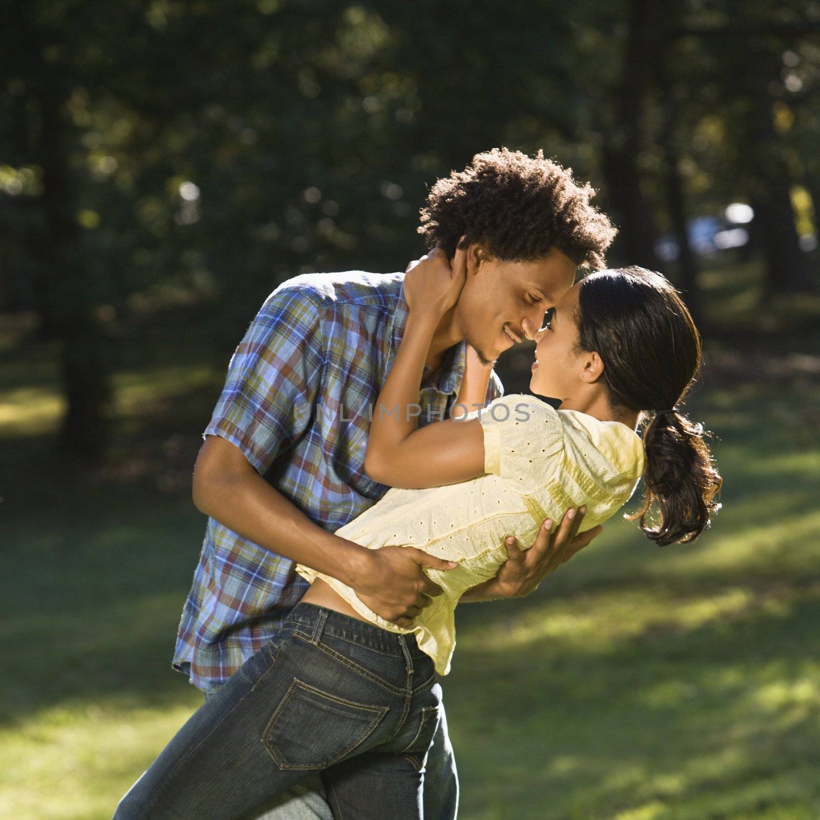 Man holding woman and dipping her down seductively while looking into her eyes.