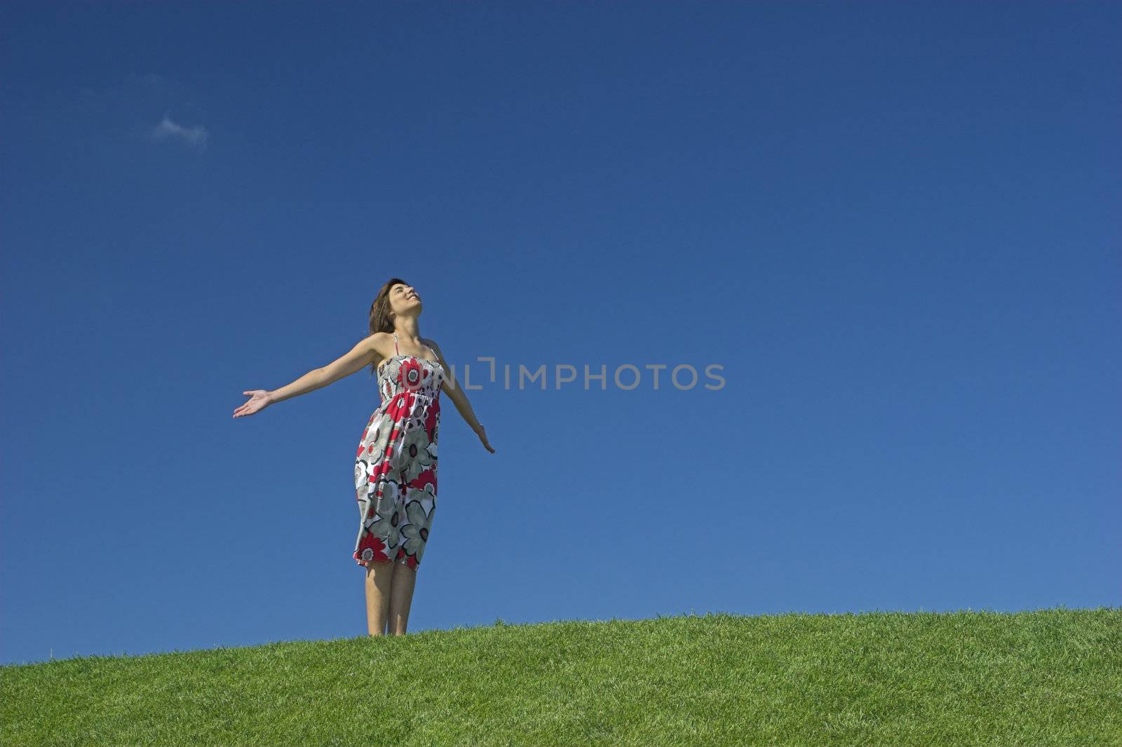 Happy woman having fun on a beautiful green meadow