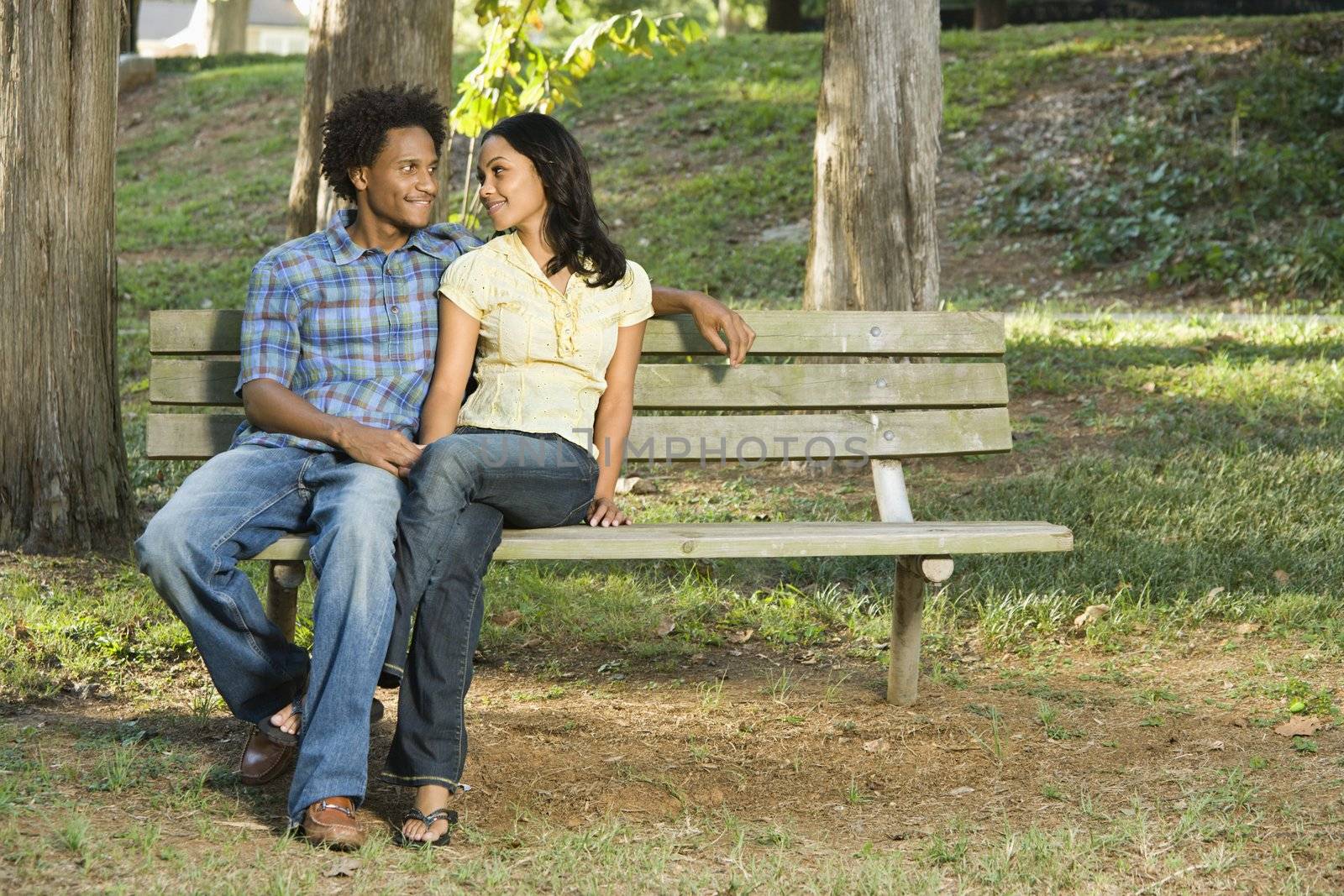 Couple on park bench. by iofoto