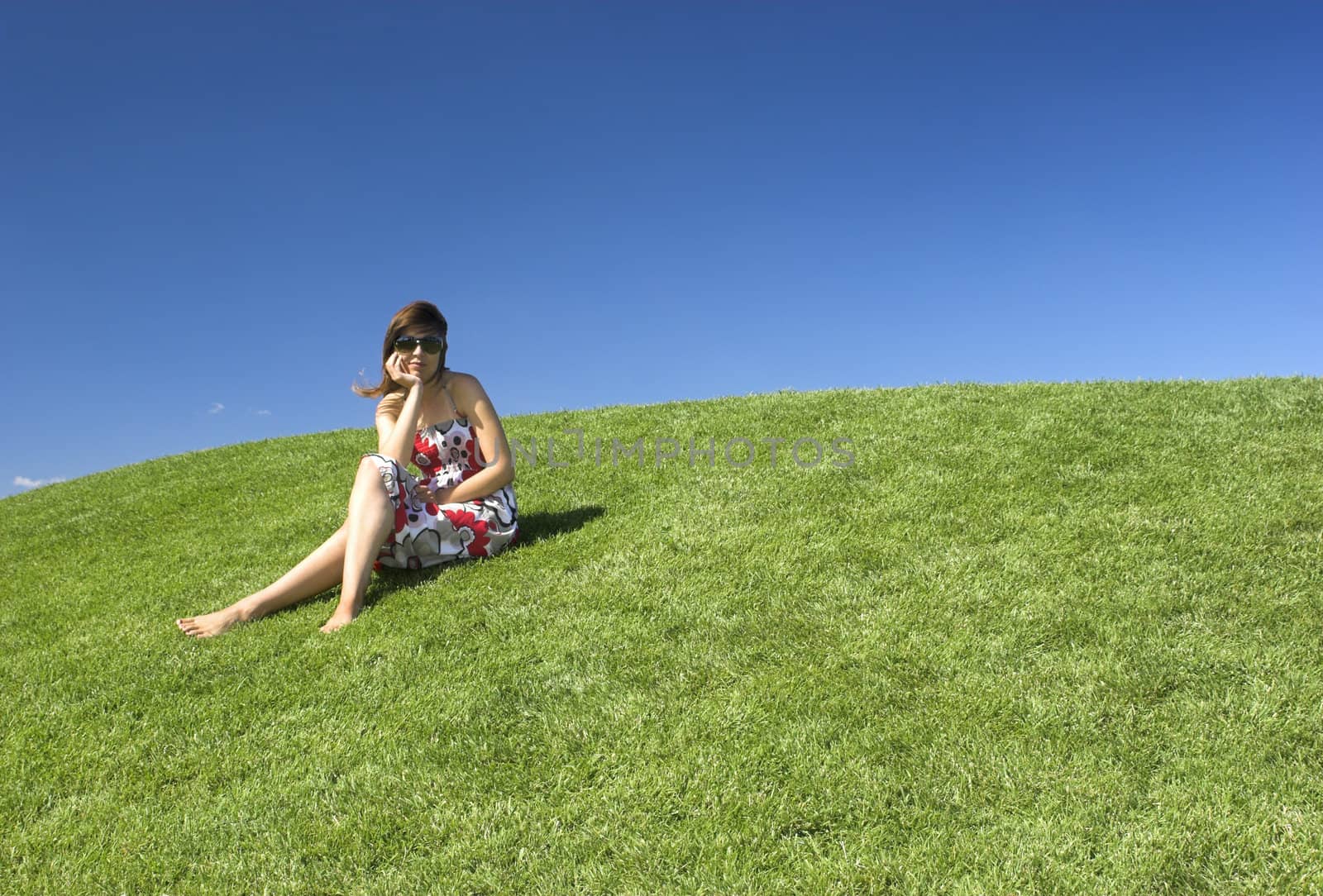 Beautiful woman relaxing on a beautiful green field