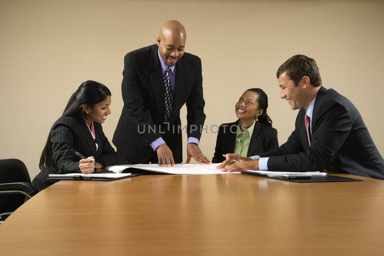 Businesspeople having meeting at conference table.