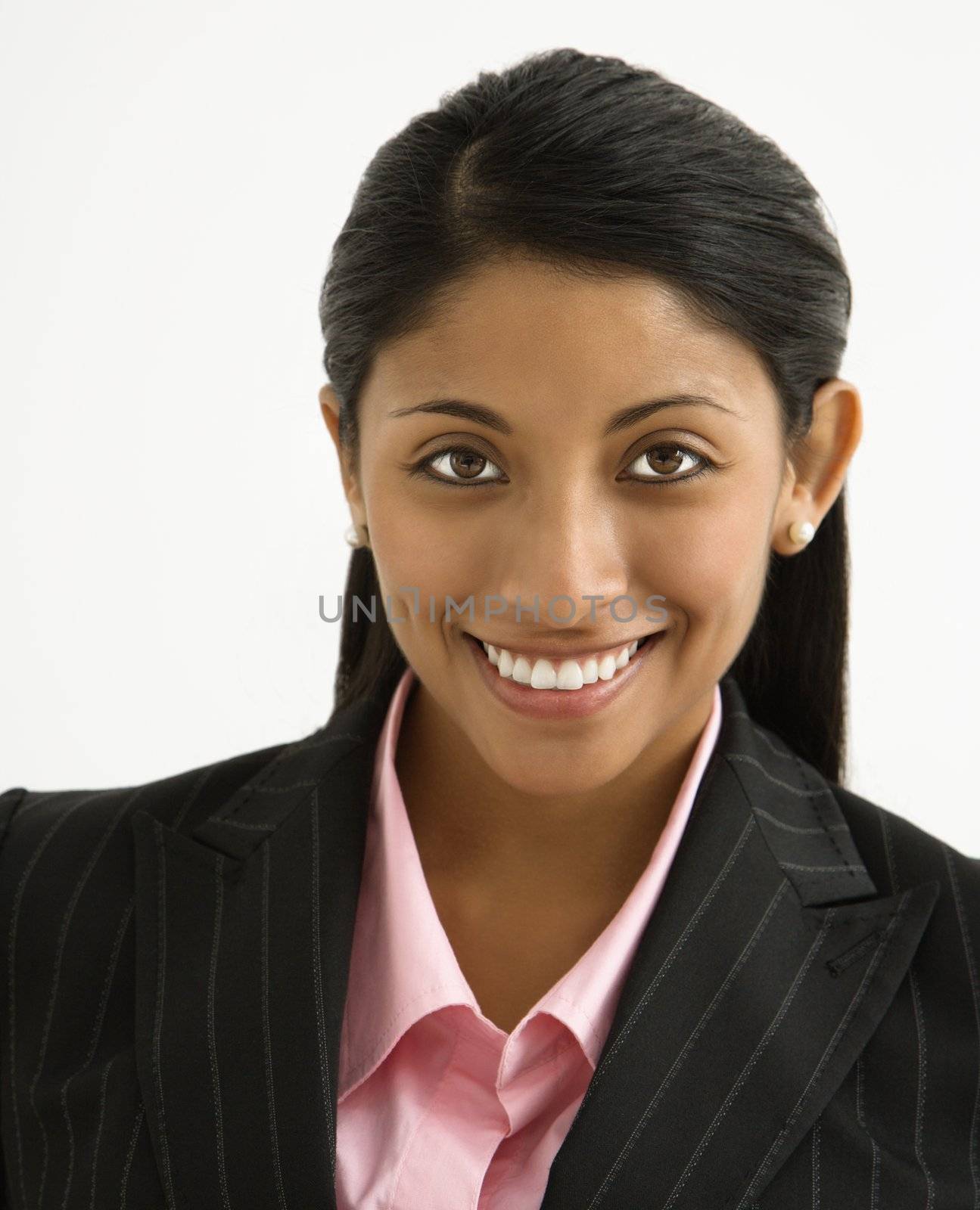 Portrait of smiling businesswoman against white background.