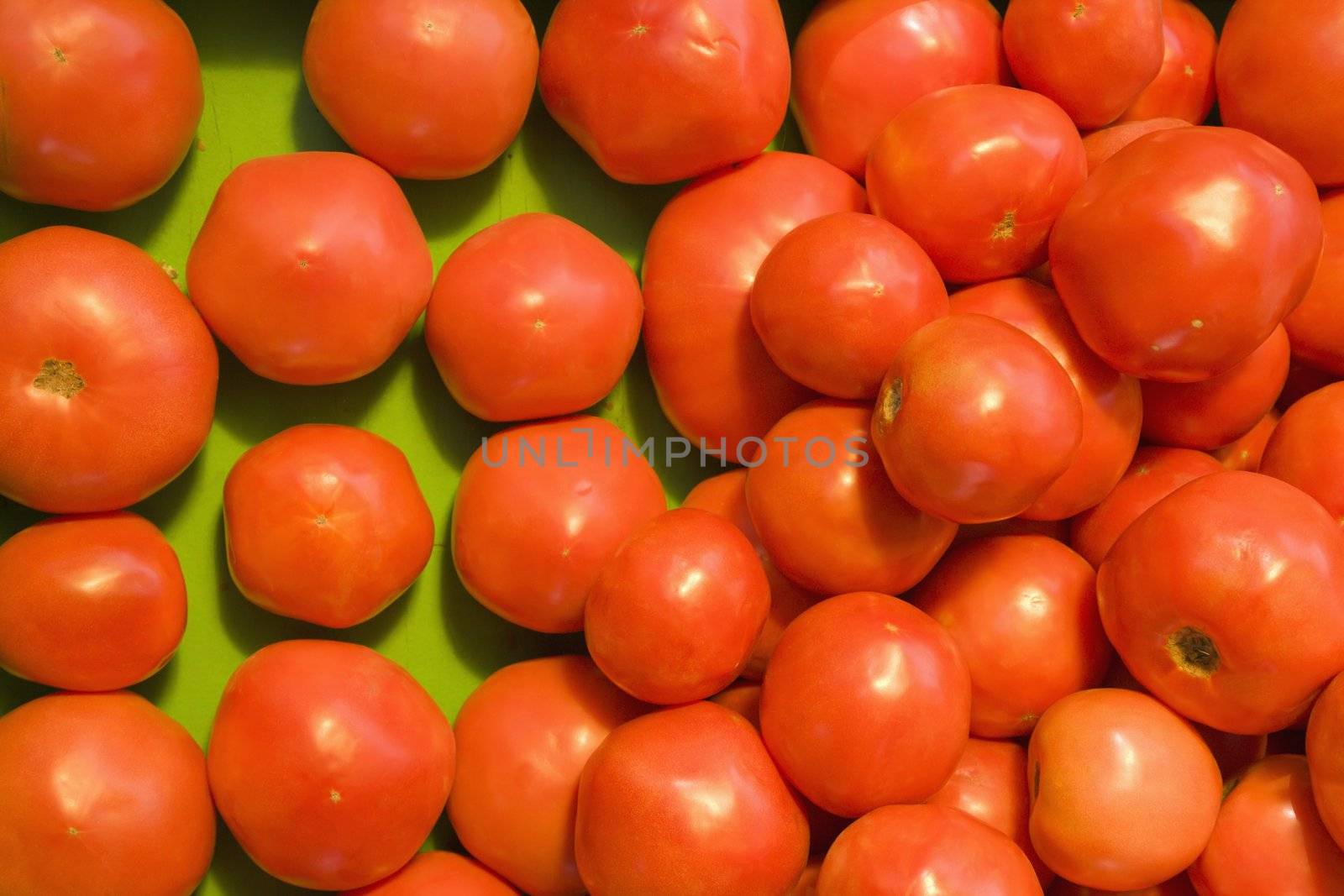 Pile of red tomatoes at produce market.