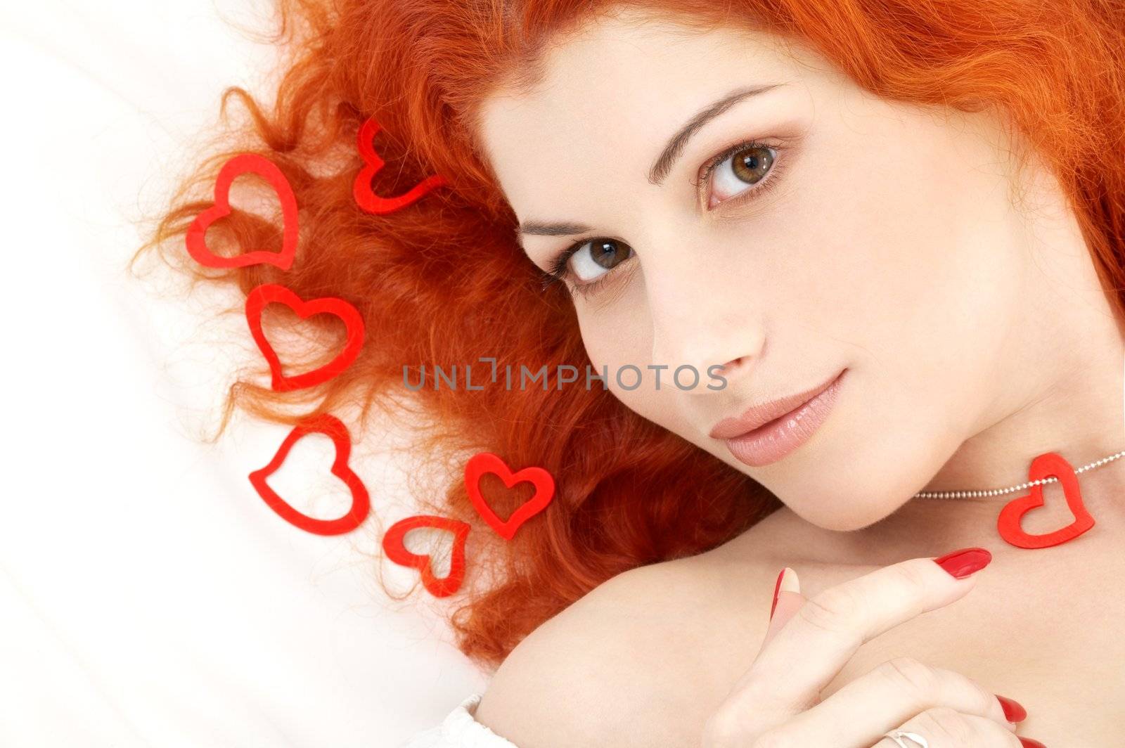 portrait of romantic redhead with read hearts