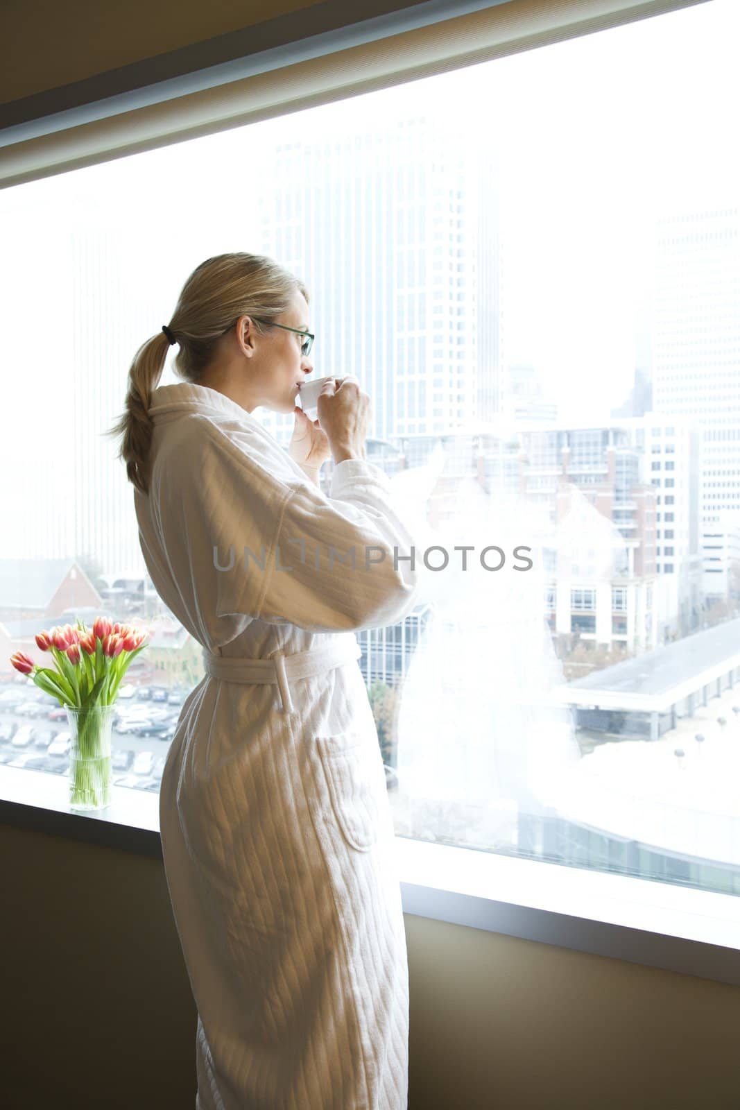 Woman drinking coffee. by iofoto