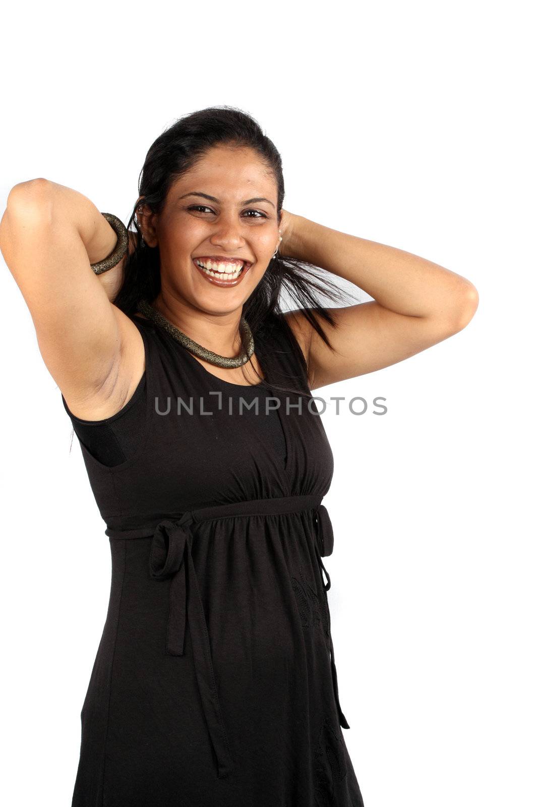 A happy Indian model styling her hair, isolated on white studio background.