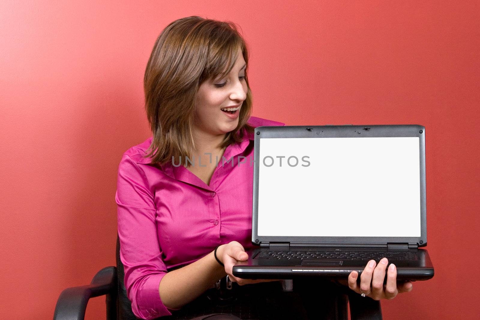Business woman with a laptop - clipping path for the screen area isolation is included.