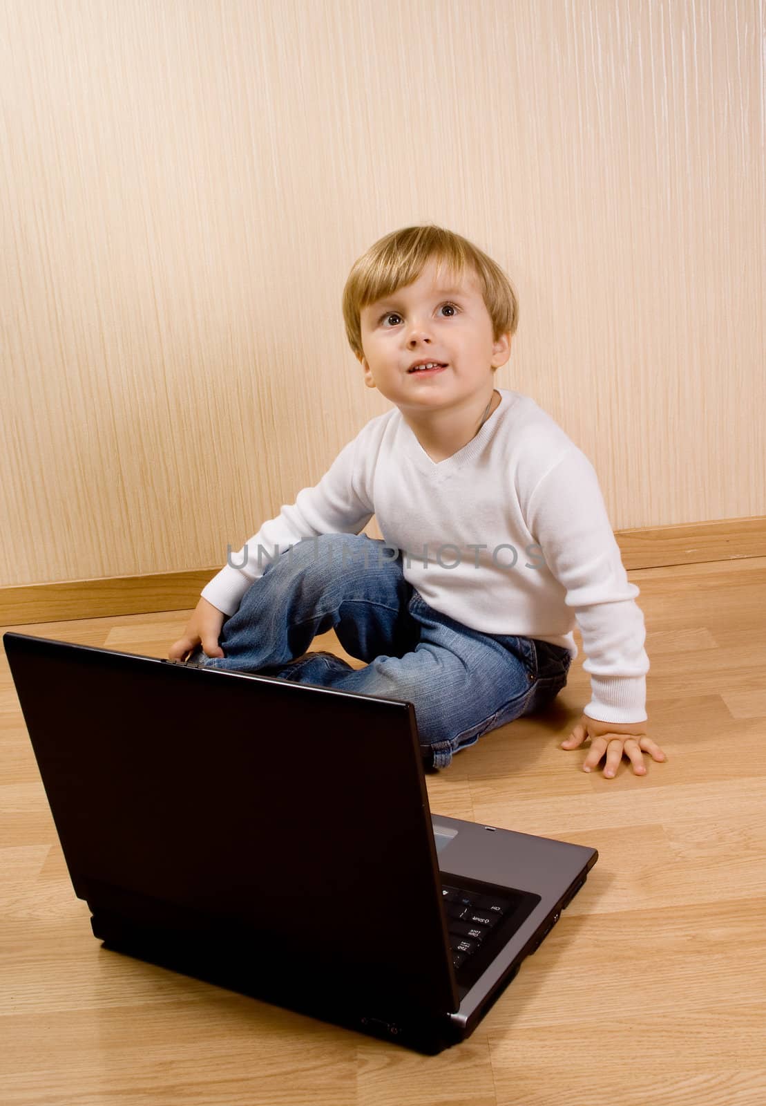 The child on the wood floor with laptop by BIG_TAU