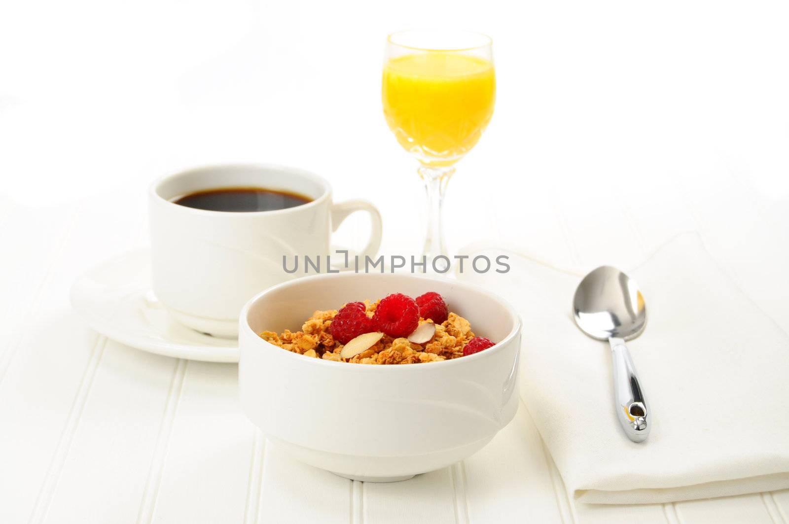 Breakfast of granola with fresh fruit and almonds.