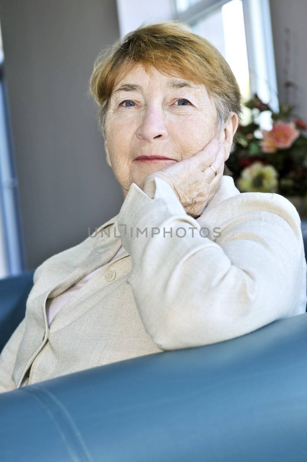 Elderly woman sitting in white linen jacket