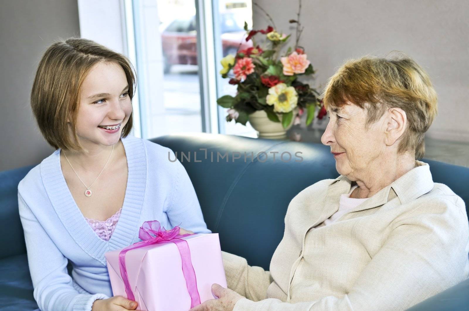 Granddaughter giving a present to her grandmother