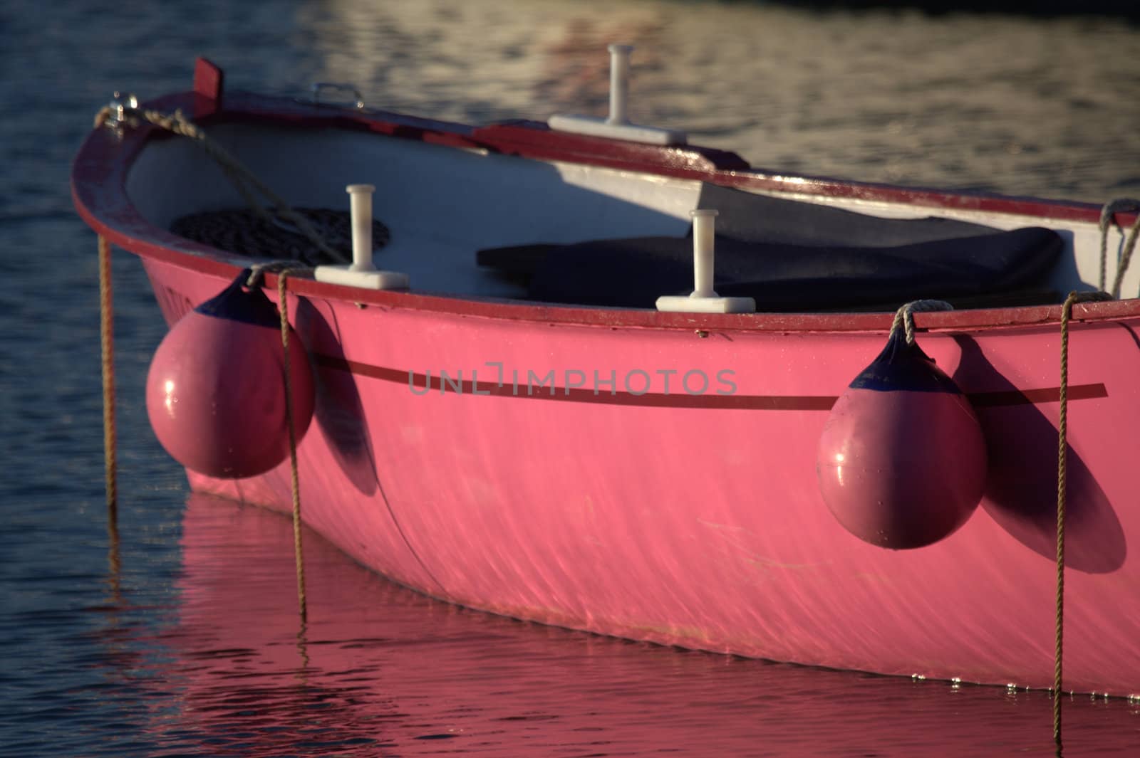 a pink boat moored in the port of Socoa near St Jean de Luz