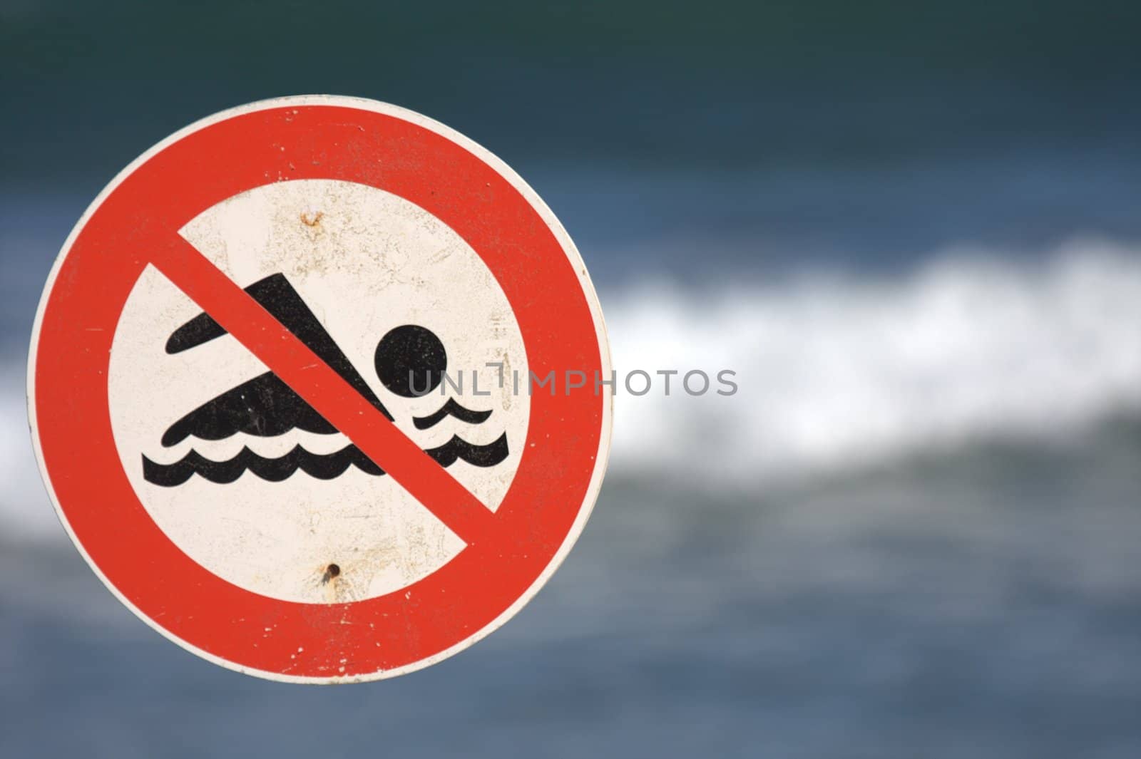 sign prohibiting bathing in the ocean, real state