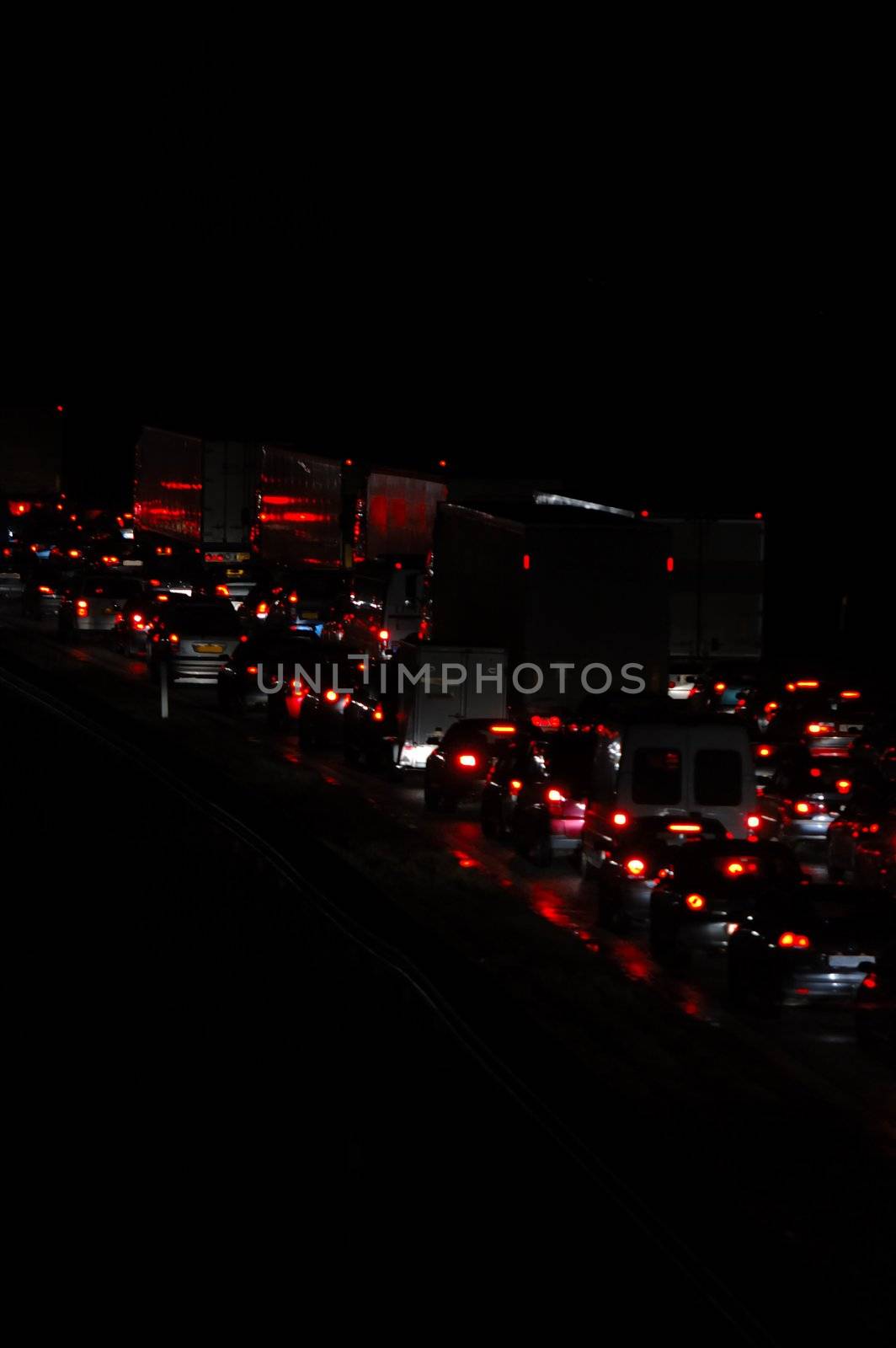 Traffic with cars and trucks. Taken at night.