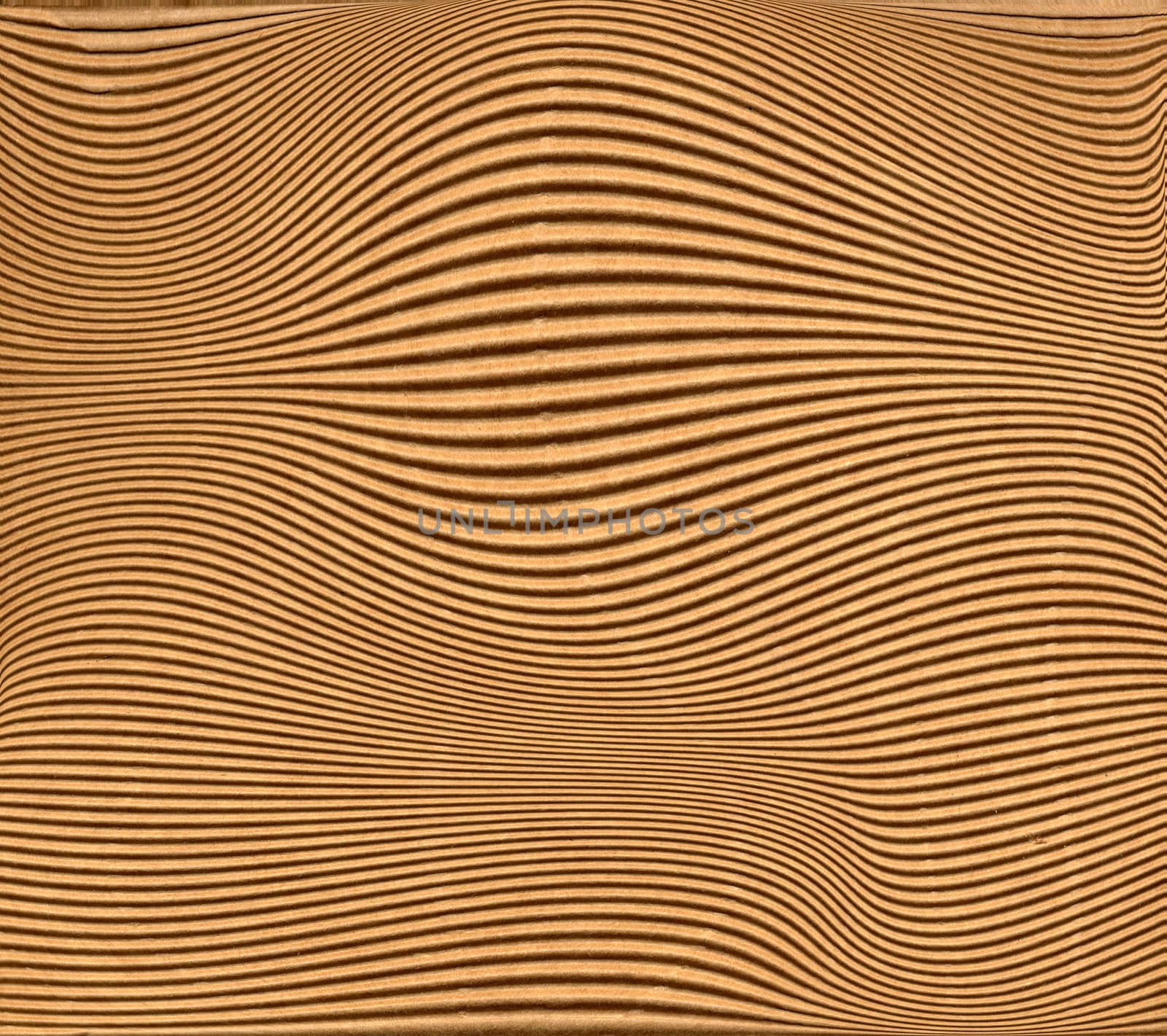 Warped brown corrugated cardboard sheet background