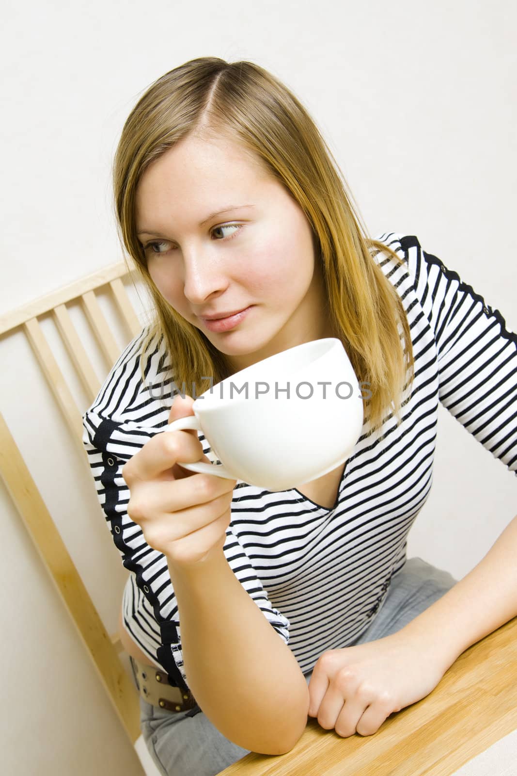 Beautiful girl holding a cup of coffee or tea