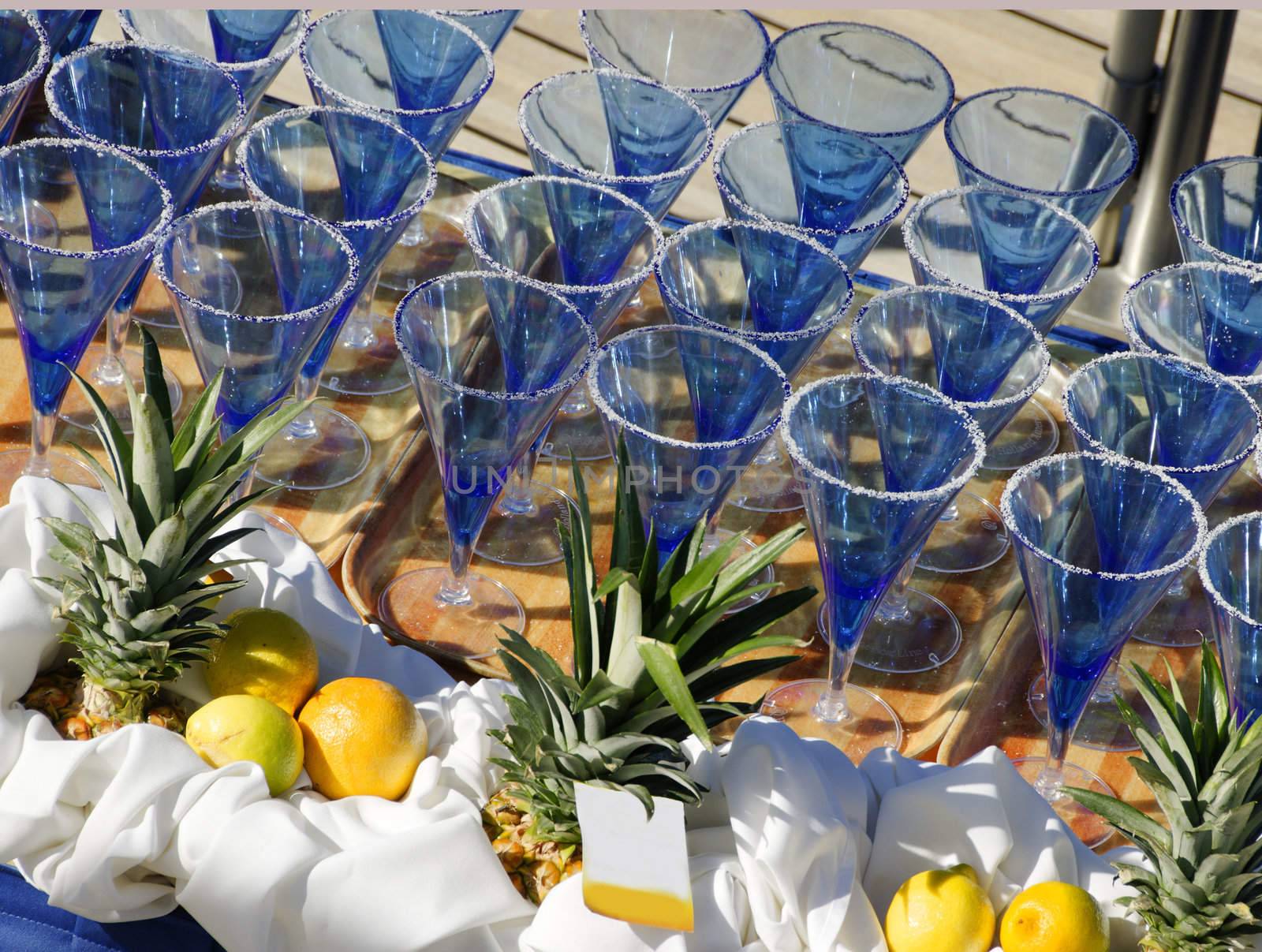 Margarita glasses lined up on a table