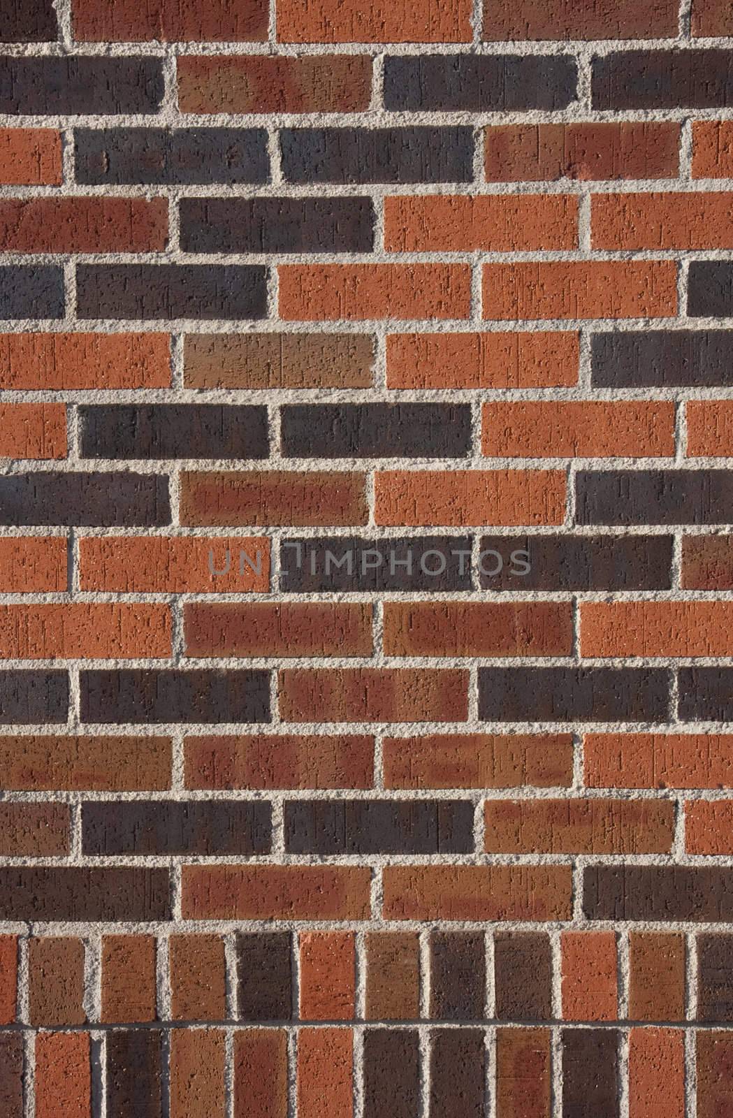 terracotta bricks of different colors from orange to dark brown, wall background