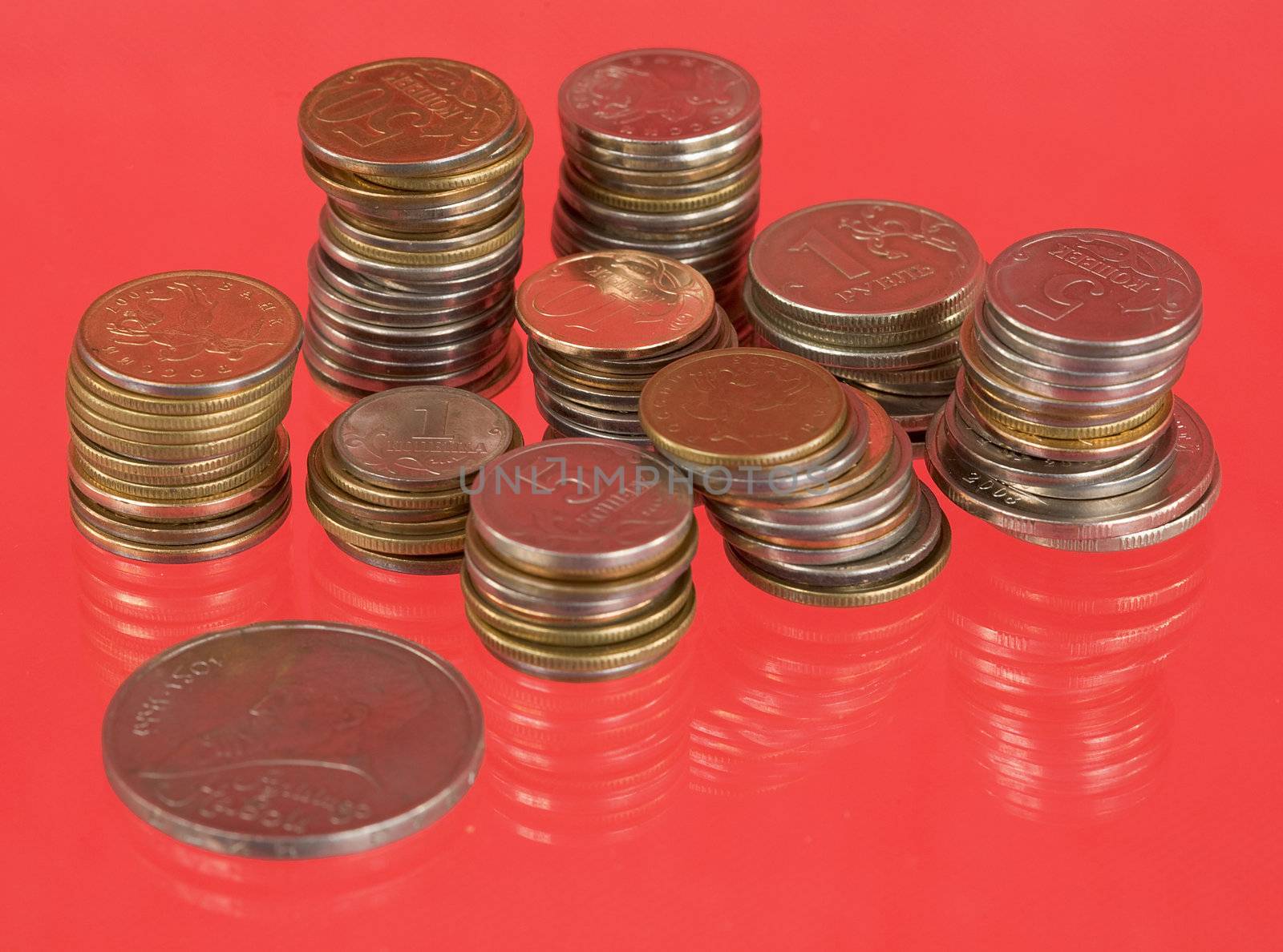 Rolls of the metal russian coins on red background