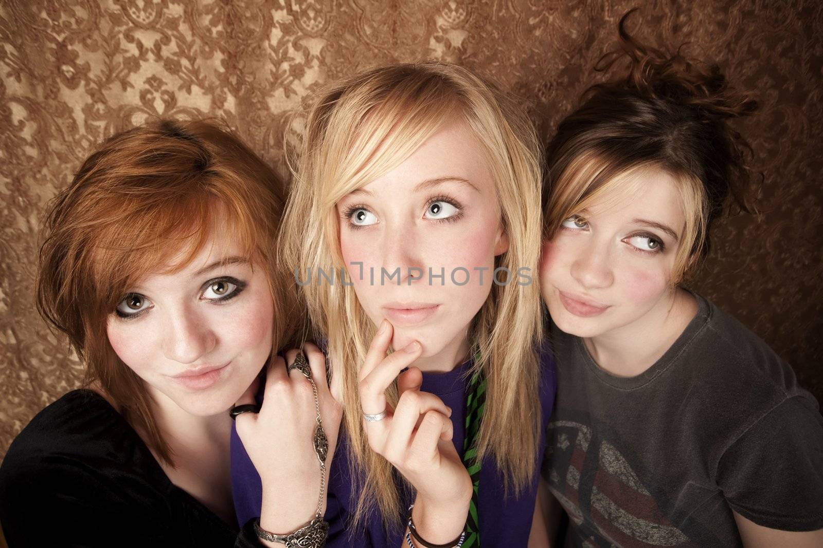 Portrait of three pretty young girls on a gold background