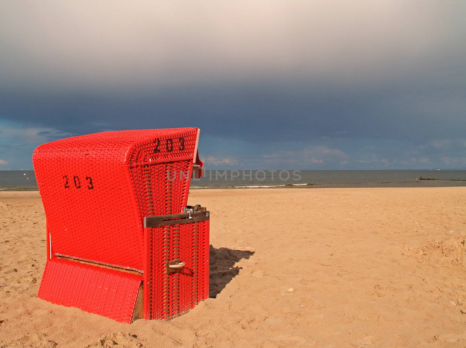 A red beach chair at the beach of Usedom, Germany