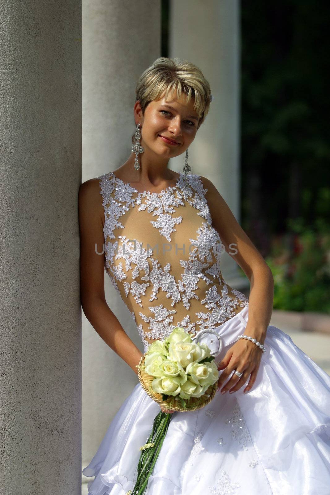 The beautiful bride with a bouquet from roses