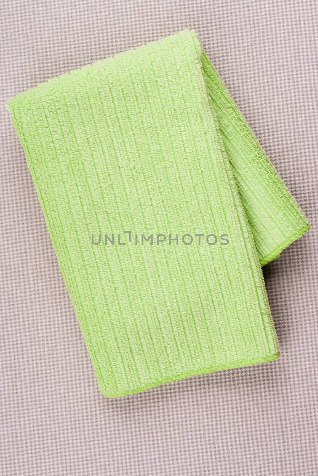 Napkin made of cloth it is light green colour for dust cleaning.