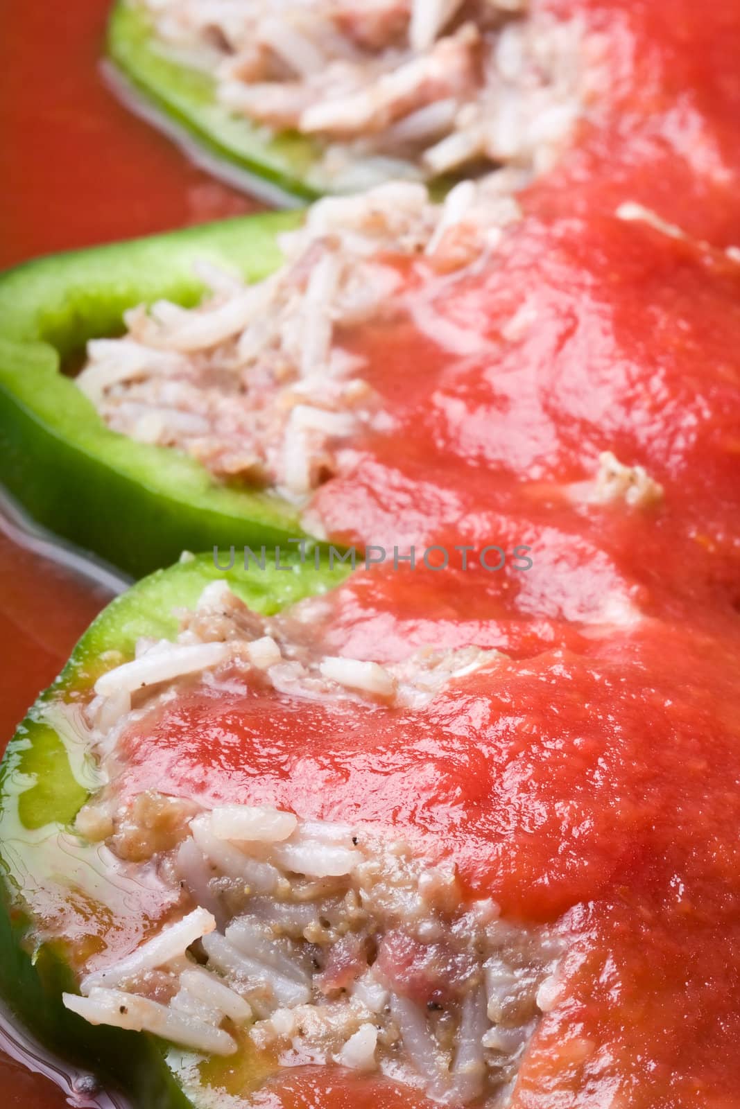 stuffed peppers cut in to slices with tomato sauce 