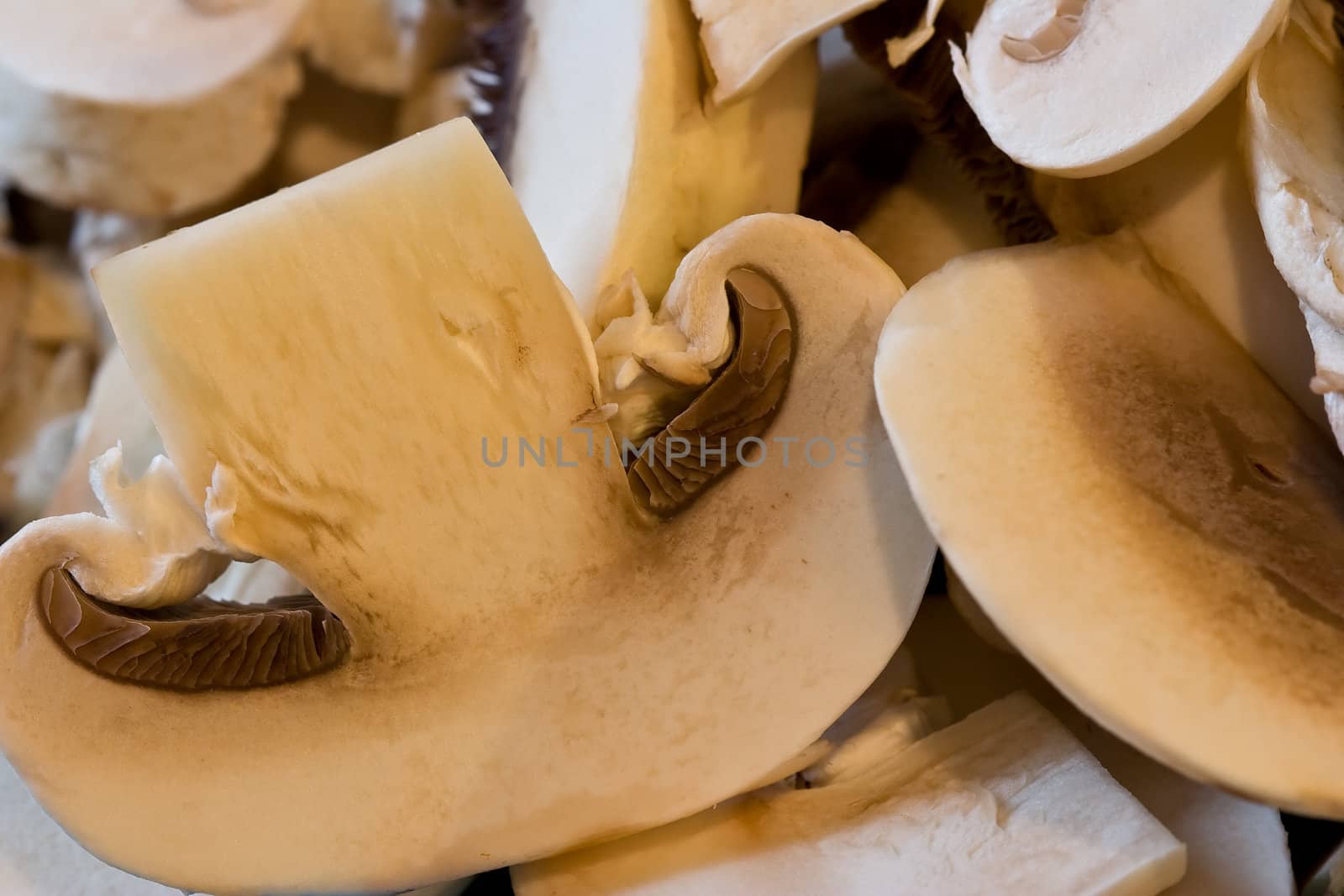 cut up mushrooms wet and sliced on a cutting board