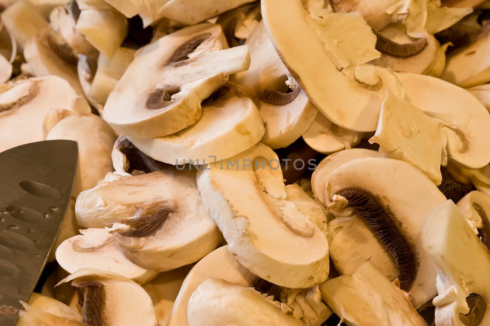 cut up mushrooms wet and sliced on a cutting board