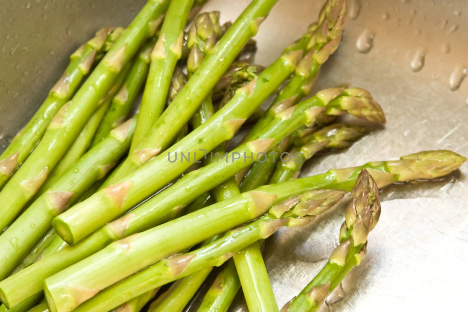 washing asparagus shot with a macro lens getting ready for a healthy dinner